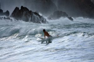 a man surfing on the waves